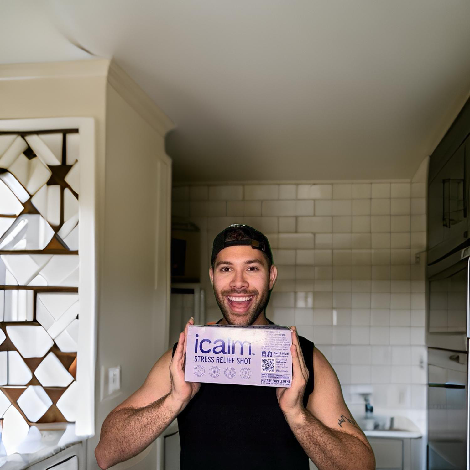 A guy very happy holding an icalm stress relief shot box