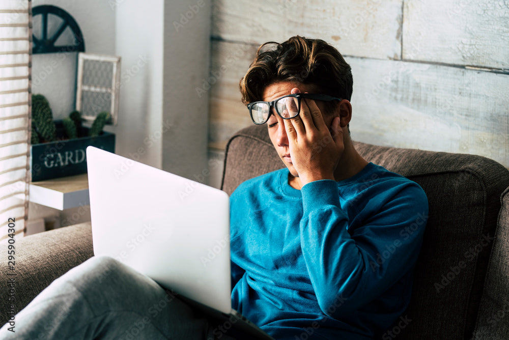 Man stressed looking at his laptop