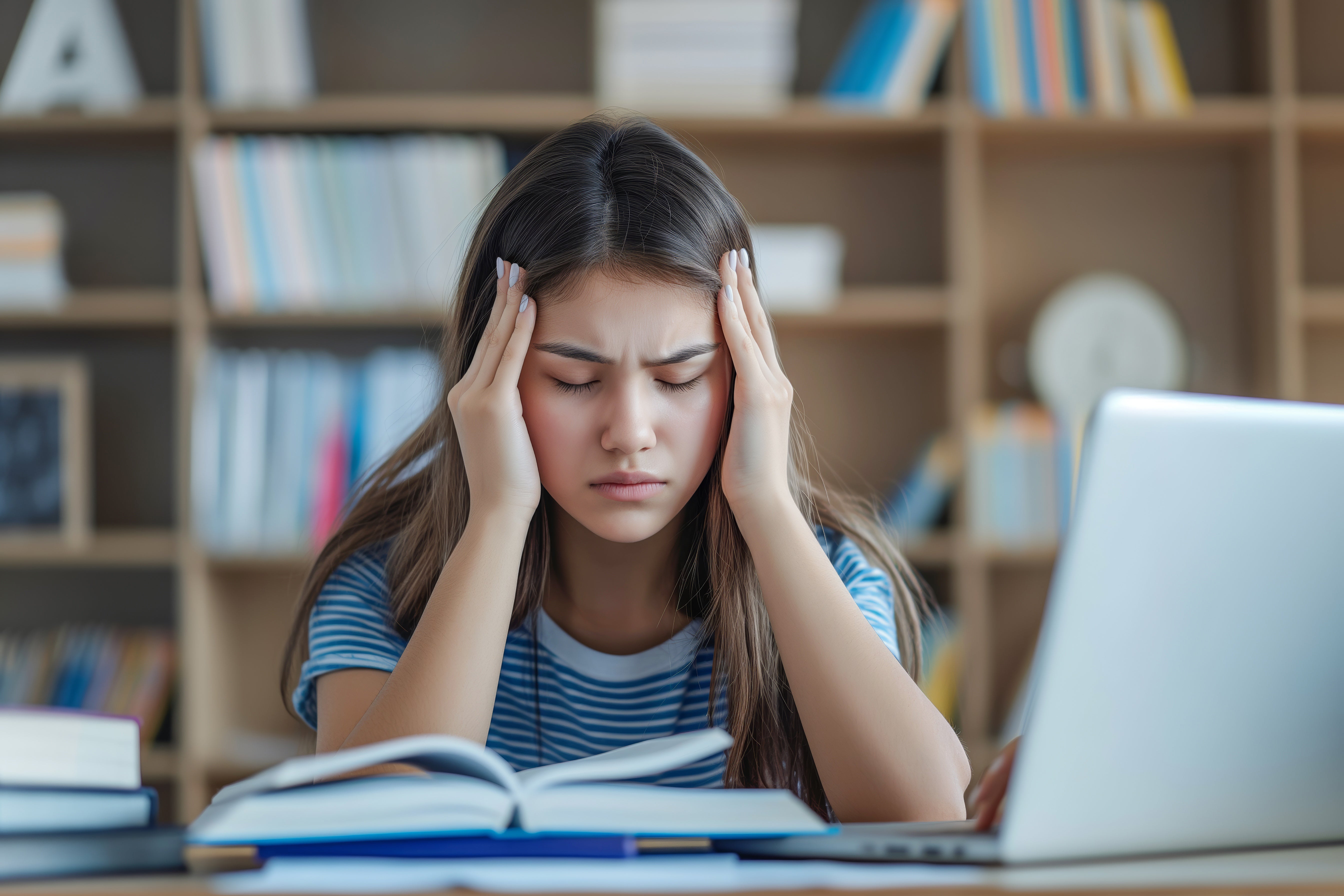 Woman having a tough time focusing, touching her forehead