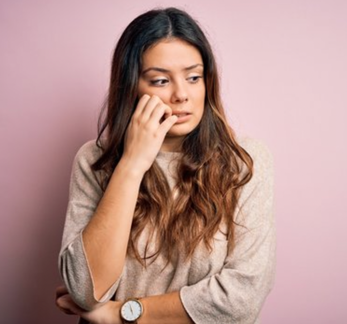 woman nervous biting her teeth