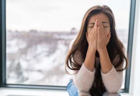 Woman covering her face